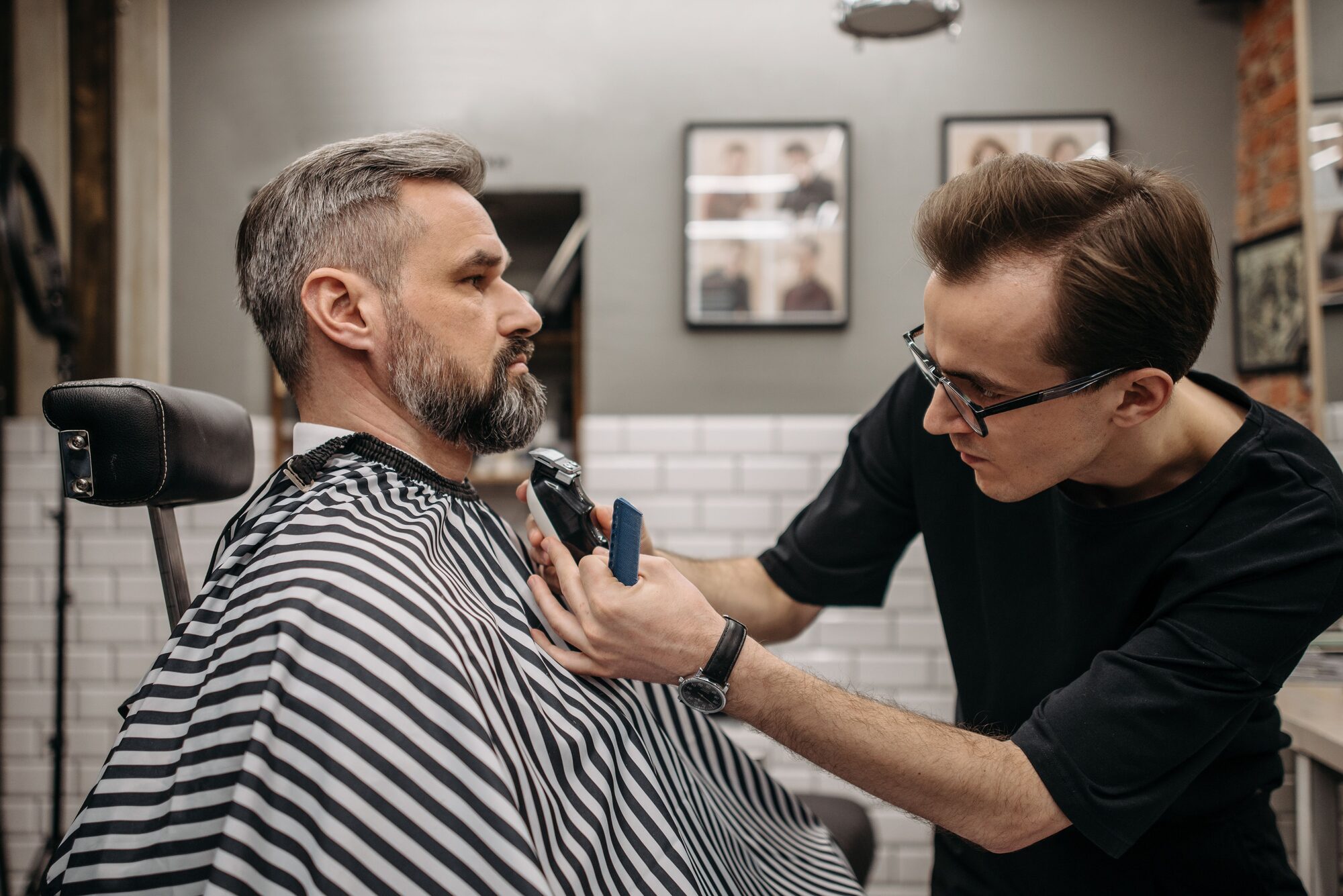 Barber trimming a client's beard