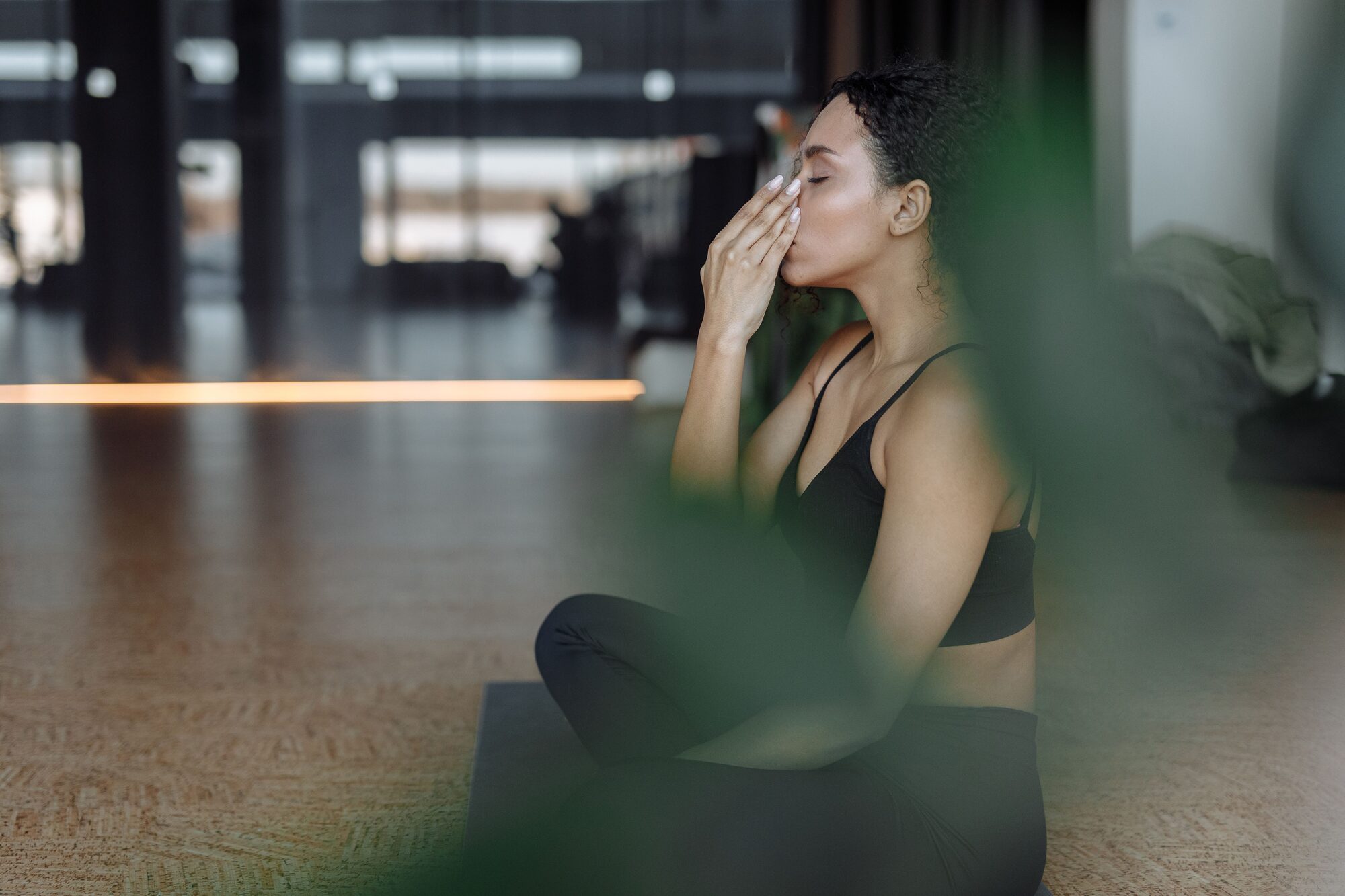 Client practicing a calming breathing exercise at a wellness studio